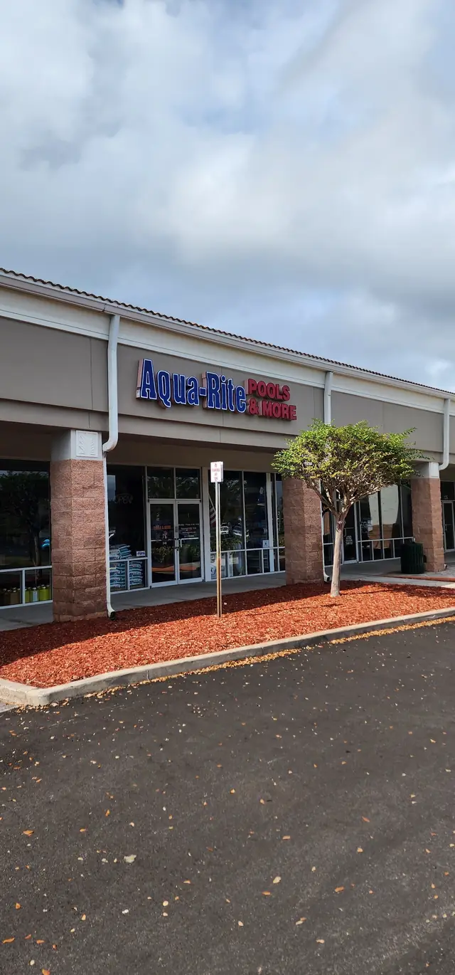 The Aqua-Rite storefront from the parking lot, brick pillars and the plaza walkway